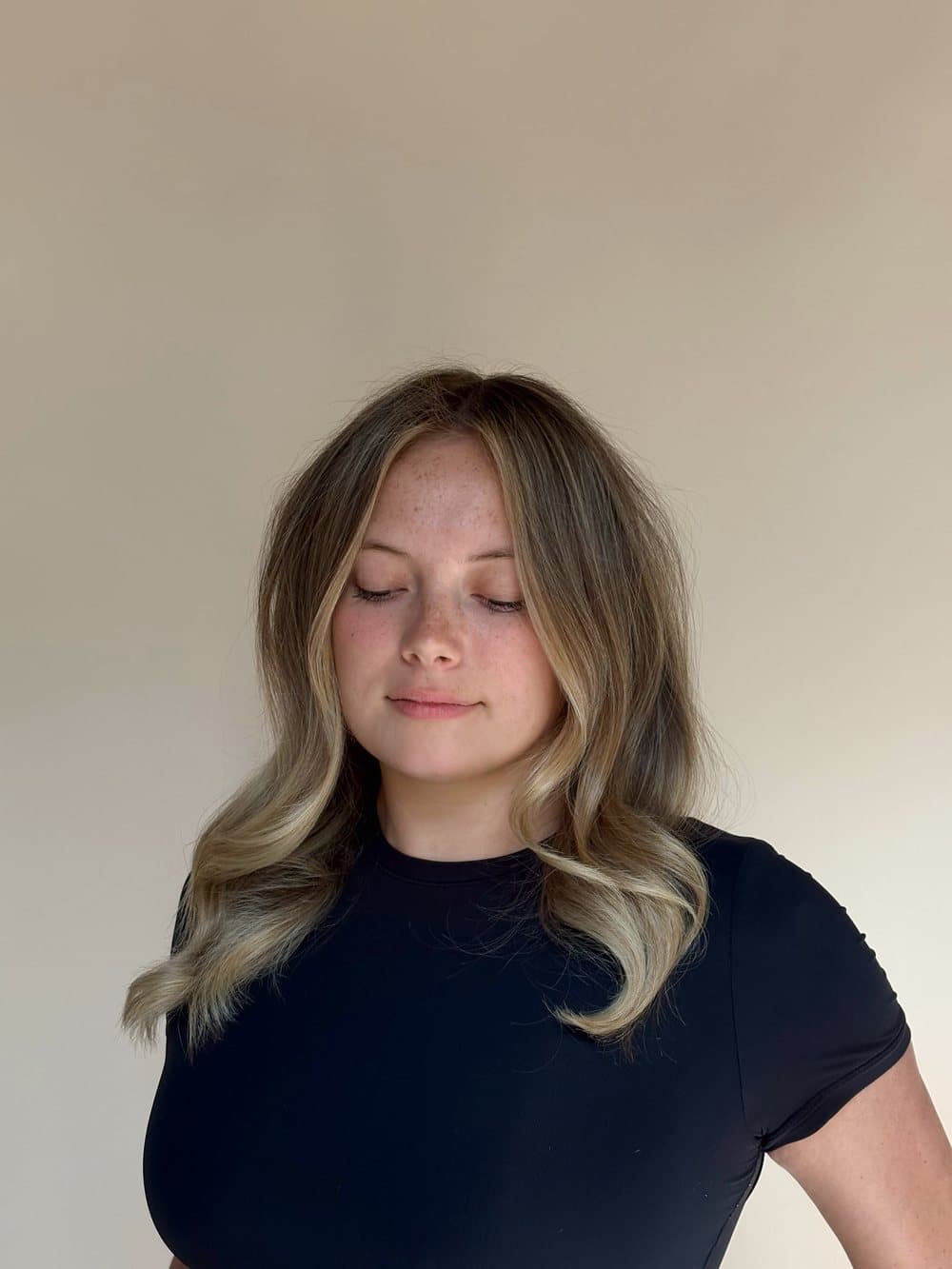 Long blonde balayage with soft waves, finished and styled